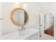 Bathroom with a marble vanity, round mirror and tile flooring at 1341 Lyndale Blvd, Winter Park, FL 32789