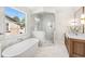 Luxurious bathroom with a soaking tub, glass shower and marble floors at 1341 Lyndale Blvd, Winter Park, FL 32789