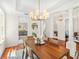 Elegant dining area with a stylish chandelier, hardwood floors, and white accents at 1341 Lyndale Blvd, Winter Park, FL 32789