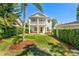 Charming two-story home with a front porch, lush landscaping, and manicured lawn at 1341 Lyndale Blvd, Winter Park, FL 32789