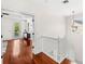Bright hallway with hardwood floors and white staircase leading to a well-lit area at 1341 Lyndale Blvd, Winter Park, FL 32789