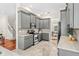 Lovely kitchen with gray cabinets, stainless steel appliances, marble countertops, and access to dining room at 1341 Lyndale Blvd, Winter Park, FL 32789