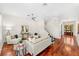 Bright living room with hardwood floors, neutral furniture, a ceiling fan, and staircase to the upper level at 1341 Lyndale Blvd, Winter Park, FL 32789