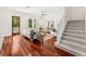 Well-lit living room with hardwood floors, neutral furniture, staircase, and view of the backyard at 1341 Lyndale Blvd, Winter Park, FL 32789
