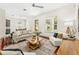 Cozy living room with hardwood floors, neutral furniture, staircase, and open access to the kitchen at 1341 Lyndale Blvd, Winter Park, FL 32789