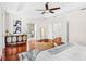 View of a main bedroom with hardwood floors, ensuite bathroom, and neutral colors at 1341 Lyndale Blvd, Winter Park, FL 32789