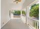 Spacious covered porch with ceiling fan and a white railing at 1341 Lyndale Blvd, Winter Park, FL 32789