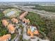 A lush and expansive aerial view showcasing community buildings, pool and adjacent golf course at 1375 Tuscana Ln # 1408, Davenport, FL 33896