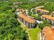 Aerial view of resort-style community with pool, landscaping, and surrounding trees at 1375 Tuscana Ln # 1408, Davenport, FL 33896