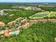 An aerial view of a community with lush landscaping, a pool, and a nearby golf course at 1375 Tuscana Ln # 1408, Davenport, FL 33896