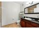 Modern bathroom featuring granite counters, dark wood cabinetry, and tile flooring at 1375 Tuscana Ln # 1408, Davenport, FL 33896