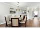 Formal dining room featuring a glass-top table, modern chandelier, and wood floors at 1375 Tuscana Ln # 1408, Davenport, FL 33896