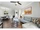 Open-concept living area with sleek furniture, wood floors, and plenty of natural light at 1375 Tuscana Ln # 1408, Davenport, FL 33896
