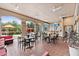 Outdoor patio area with dining tables and chairs underneath arched openings at 1375 Tuscana Ln # 1408, Davenport, FL 33896