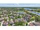 Aerial view showcases a neighborhood with mature trees, bodies of water, and well-maintained homes at 14838 Bahama Swallow Blvd, Winter Garden, FL 34787