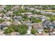 Aerial view showcases a residential neighborhood featuring mature trees, manicured lawns, and multiple homes with solar panels at 14838 Bahama Swallow Blvd, Winter Garden, FL 34787
