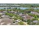Aerial view featuring lake views and a neighborhood with mature trees and well-maintained homes at 14838 Bahama Swallow Blvd, Winter Garden, FL 34787