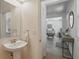 Clean and simple bathroom with a pedestal sink and easy access to the living area at 14838 Bahama Swallow Blvd, Winter Garden, FL 34787