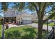Home exterior featuring a well-maintained yard, fenced property line, attached garage, and inviting outdoor patio at 14838 Bahama Swallow Blvd, Winter Garden, FL 34787