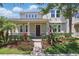 Charming two-story home featuring a landscaped yard, inviting front porch, and classic architectural details at 14838 Bahama Swallow Blvd, Winter Garden, FL 34787