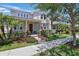 Attractive two-story home with a well-manicured lawn, inviting front porch, and classic curb appeal at 14838 Bahama Swallow Blvd, Winter Garden, FL 34787