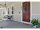 Inviting front porch with stylish seating, a welcoming doormat, and a beautifully decorated front door at 14838 Bahama Swallow Blvd, Winter Garden, FL 34787