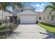 Exterior view of the home showing a two-car garage with a driveway and manicured lawn at 14838 Bahama Swallow Blvd, Winter Garden, FL 34787