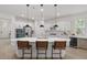 Bright and modern kitchen with quartz island, stainless steel appliances and barstool seating at 14838 Bahama Swallow Blvd, Winter Garden, FL 34787