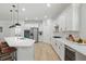 Modern kitchen with island, stainless steel appliances, and light quartz countertops at 14838 Bahama Swallow Blvd, Winter Garden, FL 34787