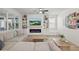 Bright living room with built-in shelving, fireplace, and large windows for natural light at 14838 Bahama Swallow Blvd, Winter Garden, FL 34787