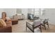 Open-concept living space with modern hardwood floors, stylish furniture, and abundant natural light at 14838 Bahama Swallow Blvd, Winter Garden, FL 34787