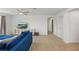 Upstairs loft featuring a TV, carpet floors, a blue sofa, and ample open space at 14838 Bahama Swallow Blvd, Winter Garden, FL 34787