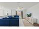 Bright loft with carpet floors, a blue sofa, a TV, and a view of the outdoors at 14838 Bahama Swallow Blvd, Winter Garden, FL 34787
