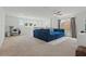 Spacious loft with large windows, carpet floors, a blue sofa, and space for a home office at 14838 Bahama Swallow Blvd, Winter Garden, FL 34787