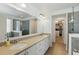 Bathroom featuring double sinks, ample counter space, walk in shower, and walk in closet at 14838 Bahama Swallow Blvd, Winter Garden, FL 34787