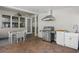 Covered outdoor kitchen featuring stainless steel grill, sink, and dining area with ceiling fan for comfortable entertaining at 14838 Bahama Swallow Blvd, Winter Garden, FL 34787