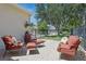 Inviting outdoor seating area with comfortable chairs, cushions, and a view of the fenced yard and neighborhood at 14838 Bahama Swallow Blvd, Winter Garden, FL 34787
