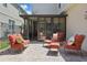 Comfortable outdoor seating area features cozy chairs, cushions, and access to an enclosed sunroom at 14838 Bahama Swallow Blvd, Winter Garden, FL 34787