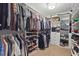 Walk-in closet with custom shelving and plenty of storage space for clothes and shoes at 14838 Bahama Swallow Blvd, Winter Garden, FL 34787