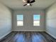 This bedroom features neutral walls, wood-look flooring, ceiling fan, and plenty of natural light from two windows at 15750 Sw 40Th Ter Sw 40Th Ter, Ocala, FL 34473