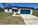 Charming single-story home featuring a modern design, blue garage door and well-manicured lawn at 15750 Sw 40Th Ter Sw 40Th Ter, Ocala, FL 34473