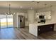 Contemporary kitchen featuring white cabinets, stainless steel appliances, and a center island with bar seating at 15750 Sw 40Th Ter Sw 40Th Ter, Ocala, FL 34473