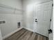 This laundry room features wood-look floors and ample space for a washer and dryer, and storage at 15750 Sw 40Th Ter Sw 40Th Ter, Ocala, FL 34473