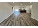Spacious living room with modern wood flooring that flows into an open kitchen area at 15750 Sw 40Th Ter Sw 40Th Ter, Ocala, FL 34473