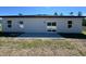 Back exterior of home with a smooth patio and sliding glass doors providing ample natural light at 15750 Sw 40Th Ter Sw 40Th Ter, Ocala, FL 34473