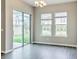 Bright dining area featuring sliding glass doors and windows overlooking the landscaped backyard at 16271 Silver Grove Blvd, Winter Garden, FL 34787
