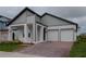 Beautiful modern home featuring a brick driveway, a two-car garage, and gray-and-white paint at 16271 Silver Grove Blvd, Winter Garden, FL 34787