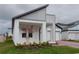 Beautiful modern home featuring a brick driveway, a two-car garage, and gray-and-white paint at 16271 Silver Grove Blvd, Winter Garden, FL 34787