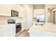 Bright kitchen with stainless steel appliances and kitchen island with sink, enhances its appeal at 16271 Silver Grove Blvd, Winter Garden, FL 34787
