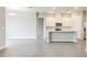 Modern, open-concept kitchen with stainless steel appliances and an island, flowing into a large, inviting living space at 16271 Silver Grove Blvd, Winter Garden, FL 34787